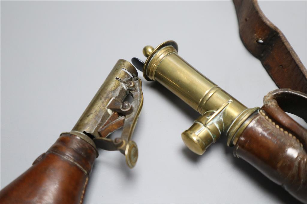 Three leather shot flasks including a Sykes Patent shot belt